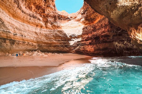 Explore the stunning Benagil cave with its natural skylight and crystal clear waters in Algarve, Portugal.