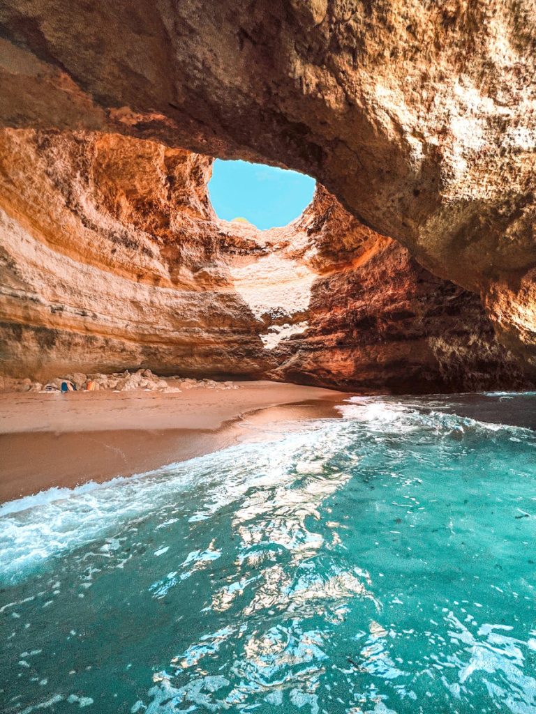 Explore the stunning Benagil cave with its natural skylight and crystal clear waters in Algarve, Portugal.