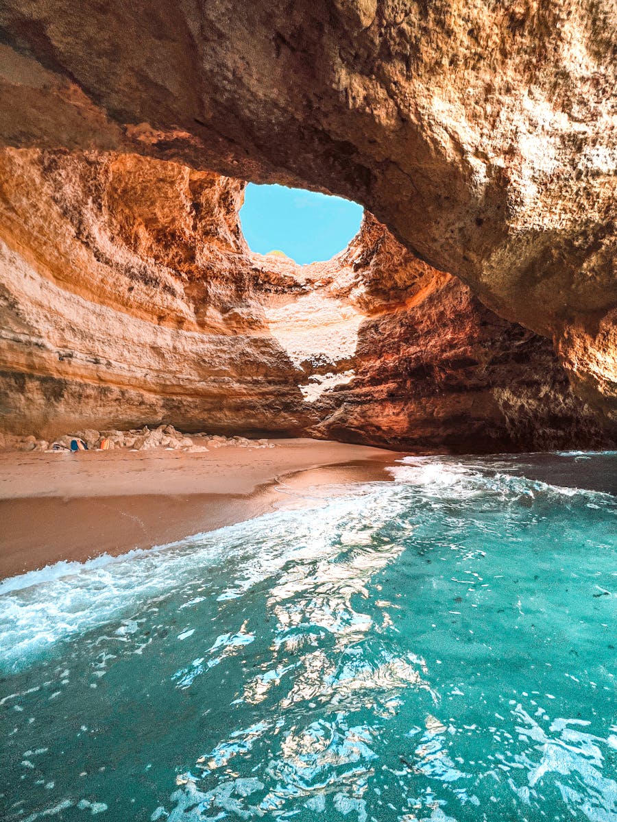 Explore the stunning Benagil cave with its natural skylight and crystal clear waters in Algarve, Portugal.