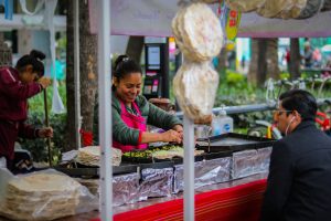 woman cooking front of man watching over