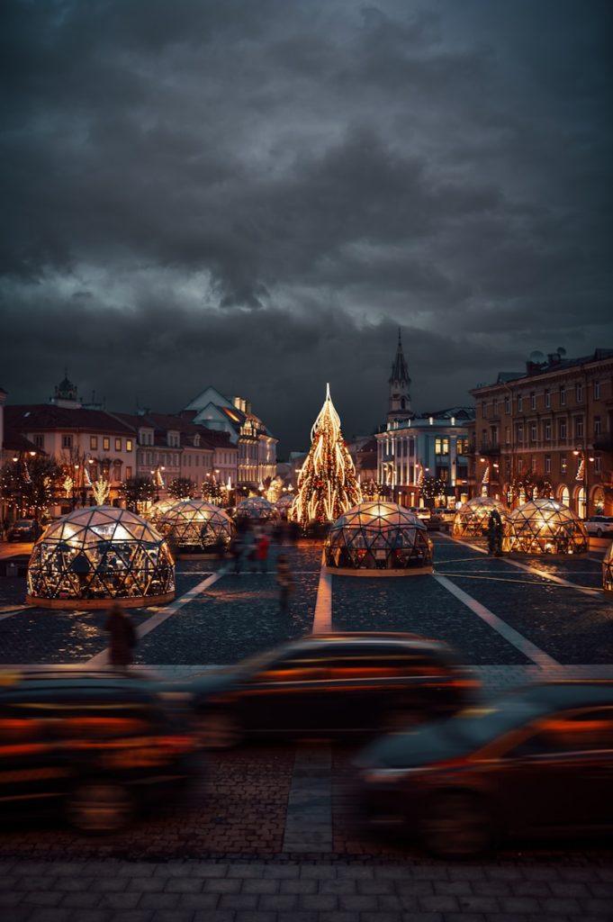 a city street with a christmas tree in the middle of it