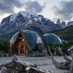 brown wooden house near mountain during daytime