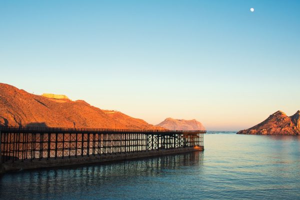 photo of brown dock near mountain