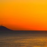 silhouette of mountain beside sea