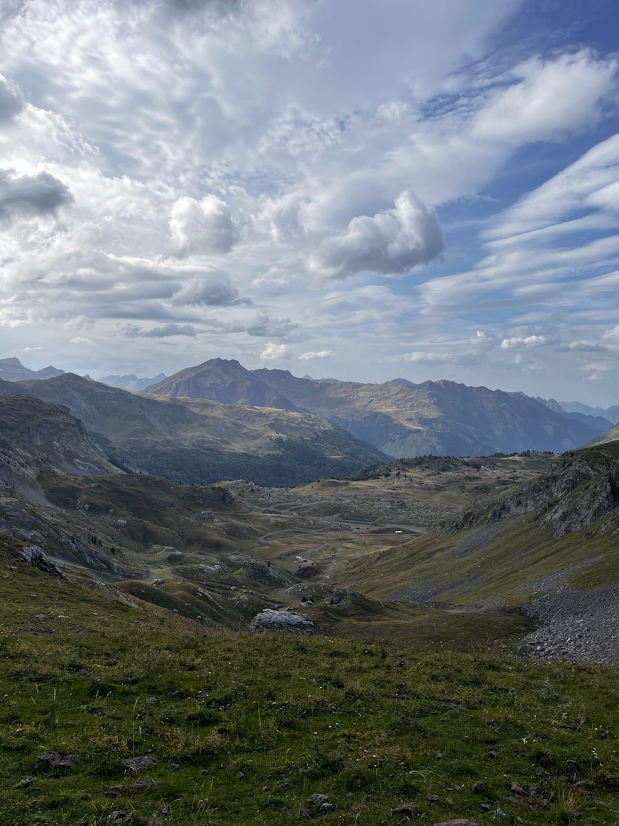 A view of the mountains from a grassy hill
