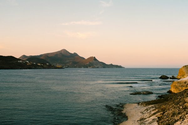 a body of water with mountains in the background