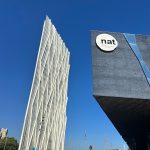 a tall building with a natt sign on it's side