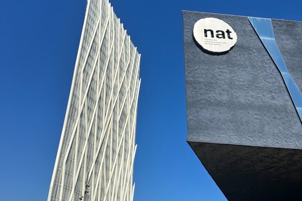 a tall building with a natt sign on it's side