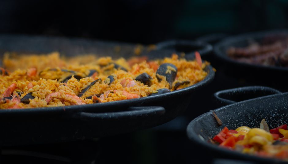 Paella de marisco cocinándose en una paellera grande